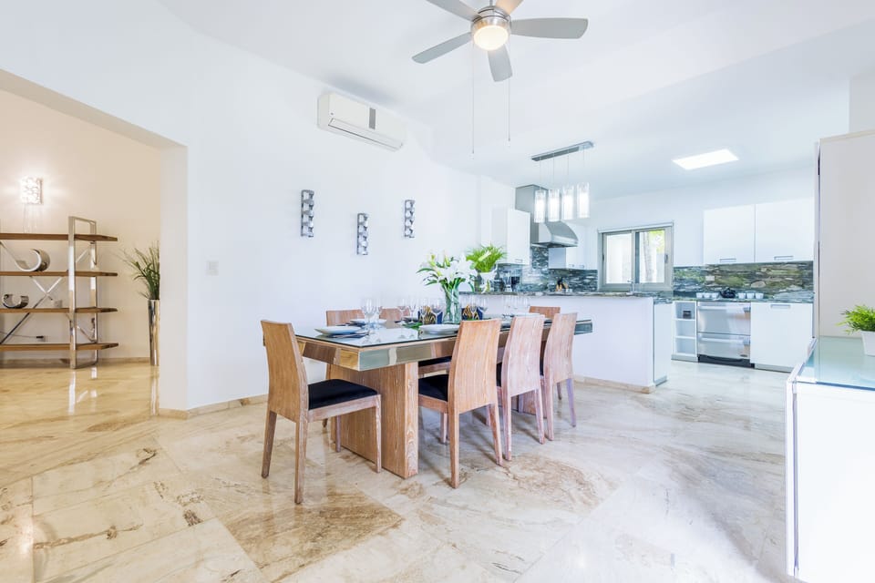 Elegant dining room with garden views and high ceilings.