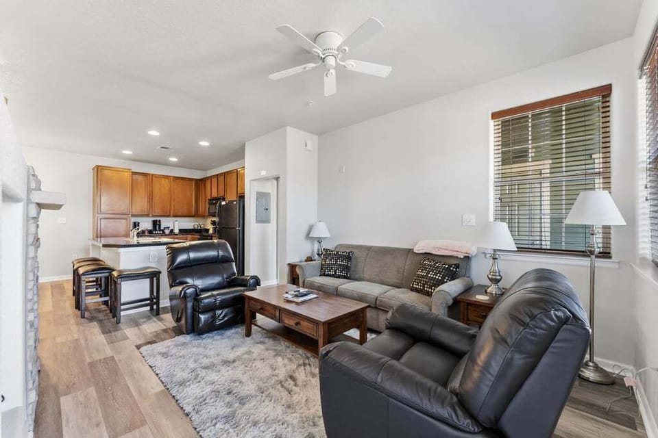 Unwind in your spacious open-concept living space with plush leather seating and a fully equipped kitchen for cooking together.