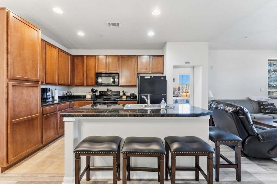 Gather around your spacious kitchen island for morning coffee or evening conversation. Rich wood cabinets and granite countertops create your perfect culinary retreat.