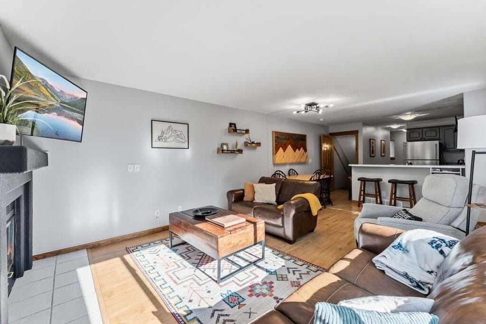 Settle into your cozy living space with leather seating, mountain views on the big screen, and an open kitchen.