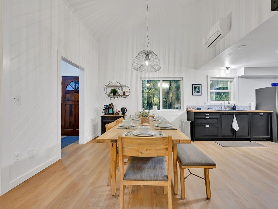 Spacious dining area with vaulted ceilings and open kitchen—perfect for group meals.