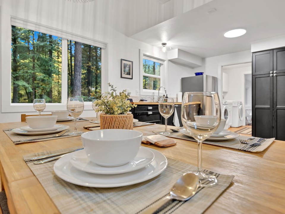 Elegant dining setup ready for memorable meals with peaceful forest views.