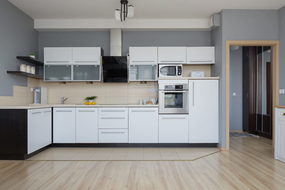 The sleek design of the kitchenette blending seamlessly with the living area.