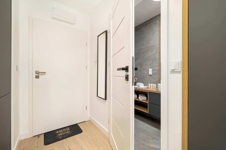 Bright hallway with large mirror.