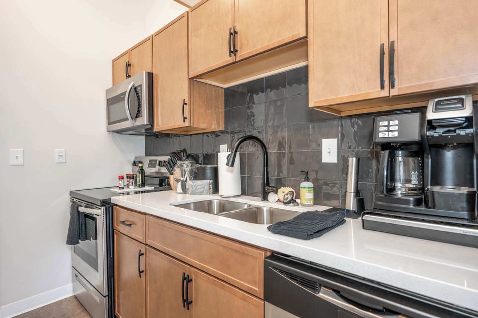 The sleek, open kitchen offers ample storage & every home comfort​