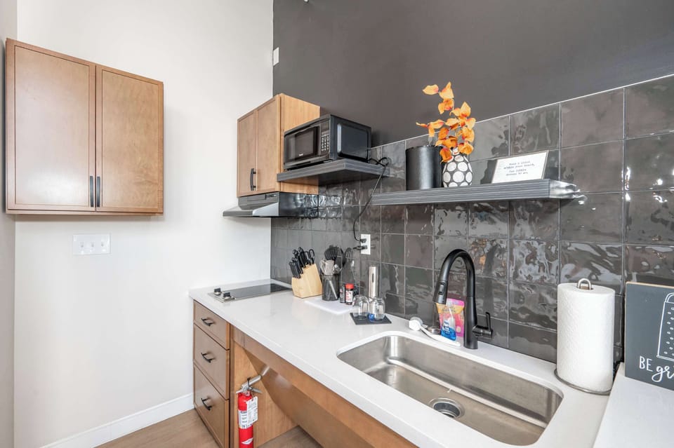 The sleek, open kitchen is equipped with all the comforts of home​