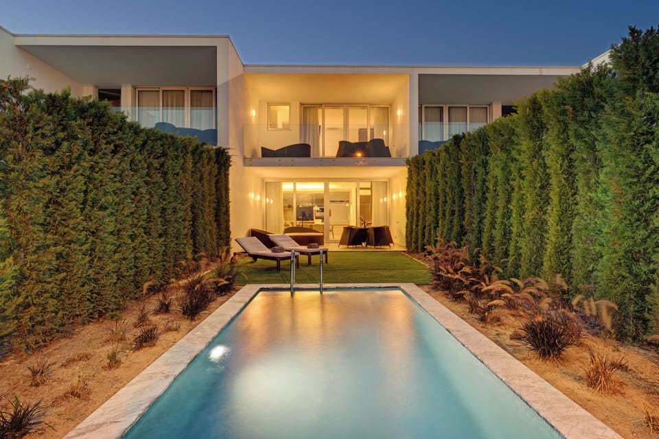 Soak in golden-hour calm beside the illuminated private pool.