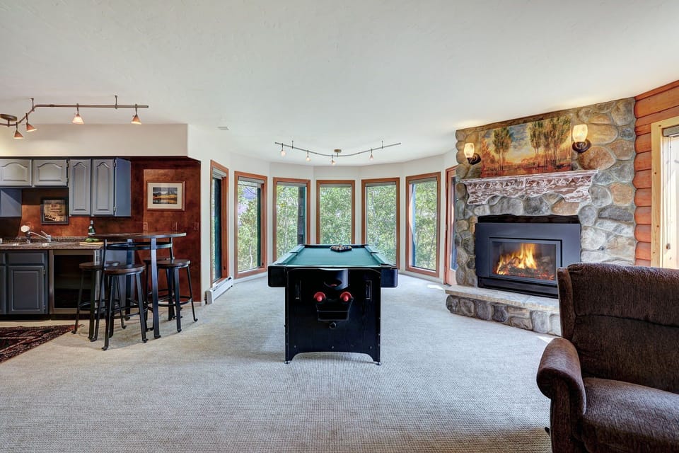 cozy fireplace, game table, and a wet bar