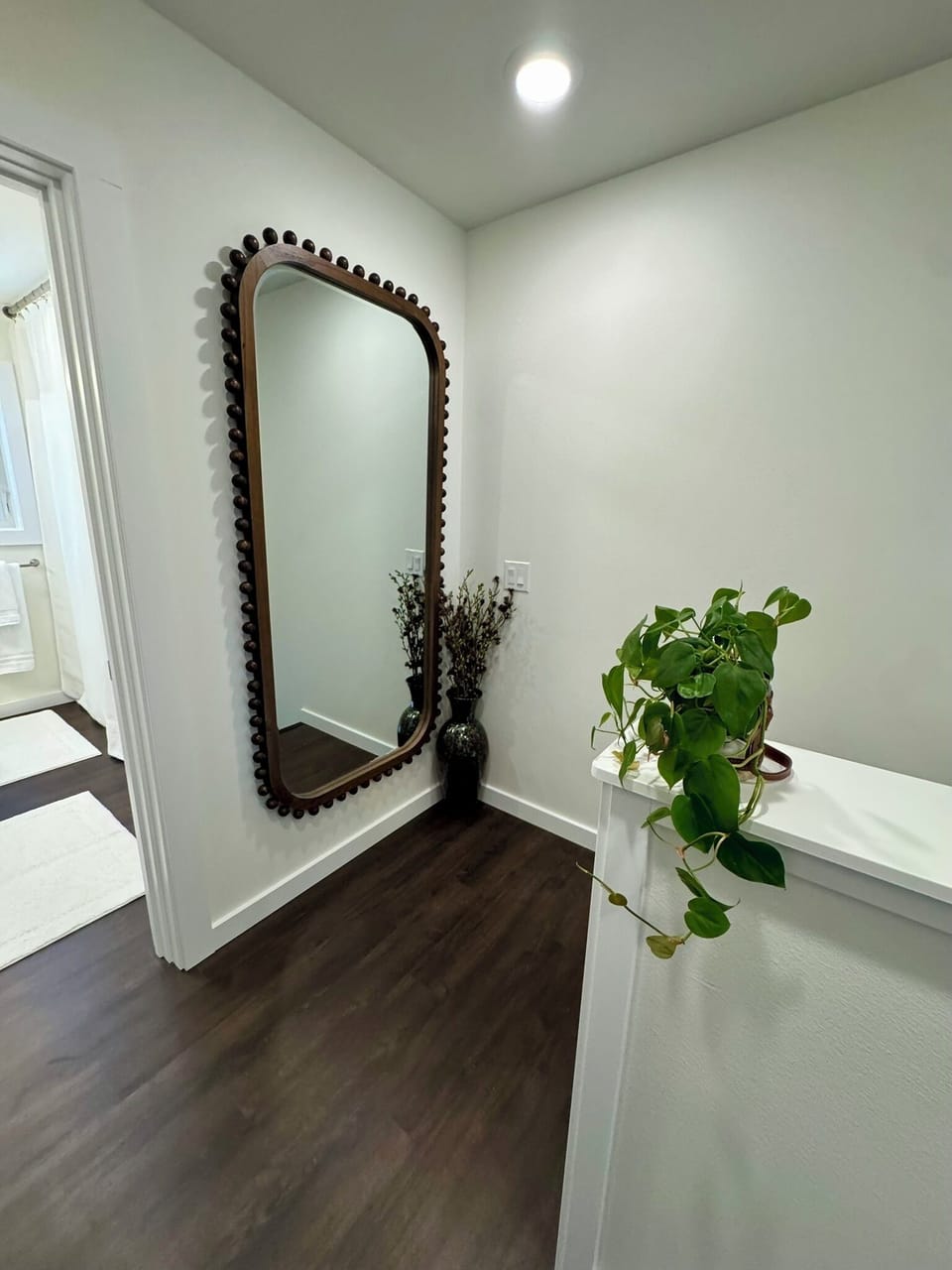 Stair landing with oversized, full-length mirror.