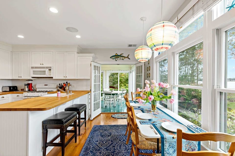 Dining area for four with stunning waterfront views, a beautiful place to share meals overlooking Town Cove