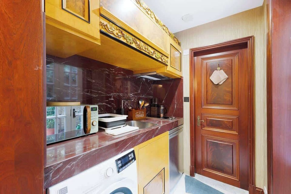 Kitchen equipped with all essentials, including a washer & dryer, fridge and full cookware set.