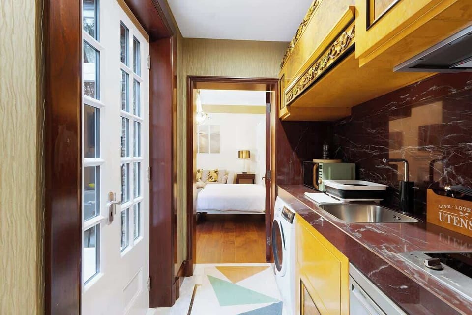 Kitchen equipped with all essentials, including a washer & dryer, fridge and full cookware set.