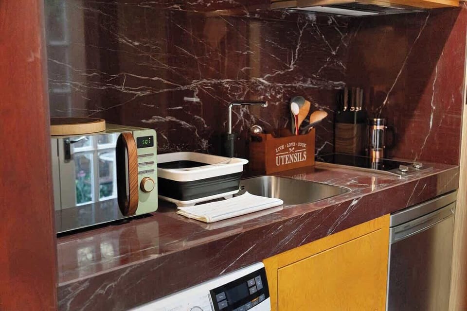 Kitchen equipped with all essentials, including a washer & dryer, fridge and full cookware set.