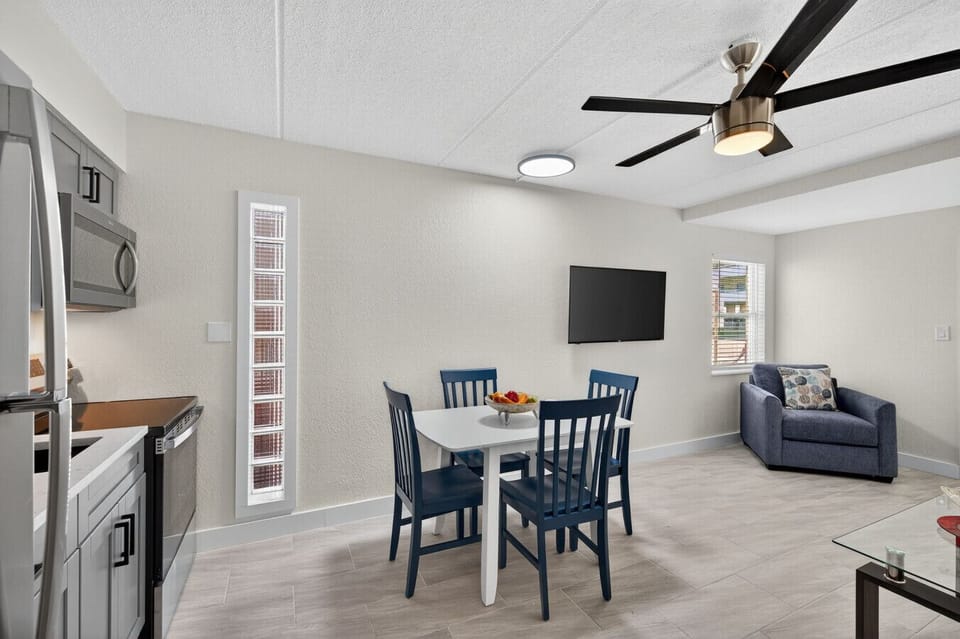 Open living & dining area w/ high ceilings, ceiling fan, and easy flow for gathering or meals.