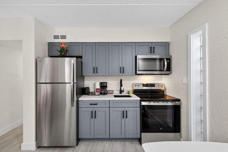 Modern kitchen w/ stainless steel appliances, ample cabinets, and everything set for easy meals.