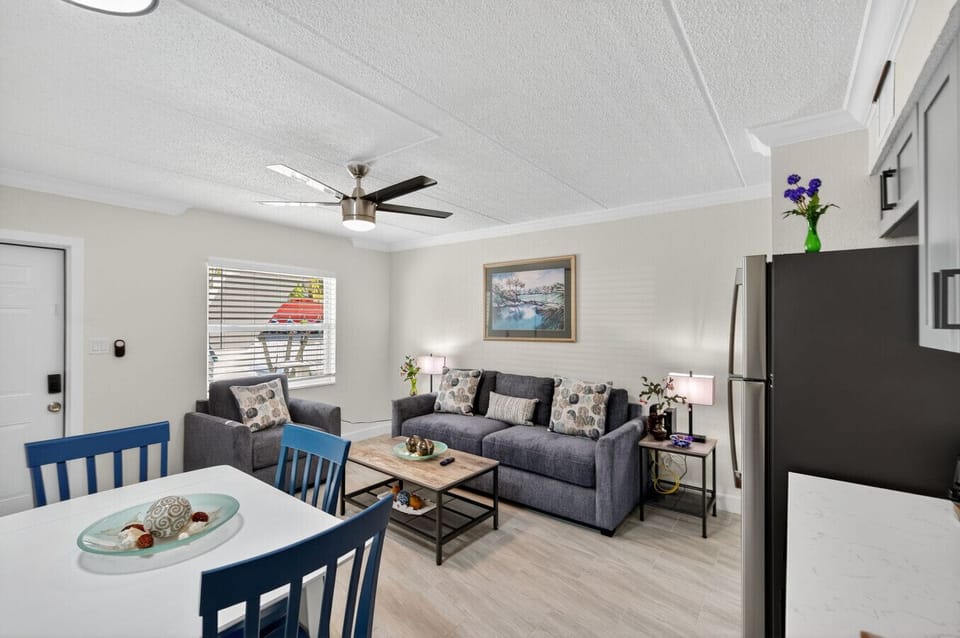 Open living area w/ comfy seating & TV, flowing seamlessly into the kitchen for relaxed hangouts.