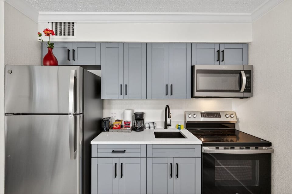 Modern kitchen w/ stainless steel appliances and clean finishes, ready for everything from snacks to full meals.