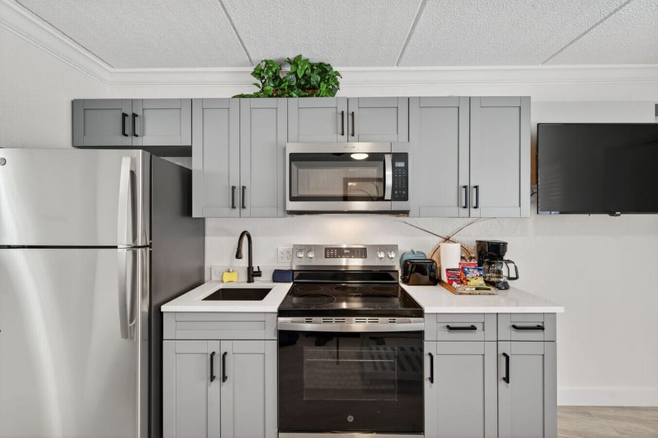Sleek kitchen w/ stainless steel appliances & ample counter space for easy home cooking