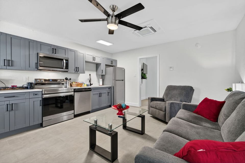 Inviting living space w/ comfortable seating & a clean, modern kitchen backdrop