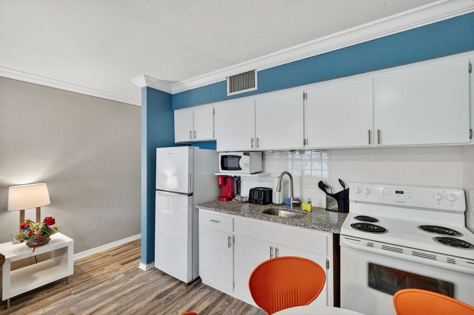 Bright kitchen w/ white cabinetry and clean lines, perfect for easy meals and snacks.