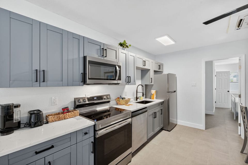 Modern kitchen w/ stainless appliances, ample counter space, & sleek cabinetry