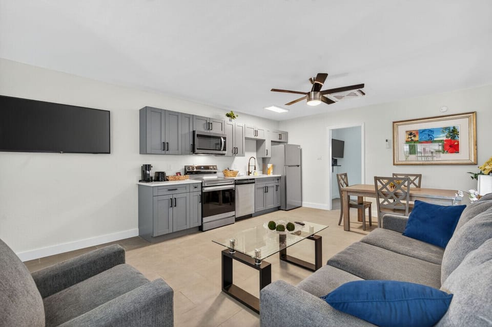 Airy main living area w/ updated kitchen, dining table, & cozy seating