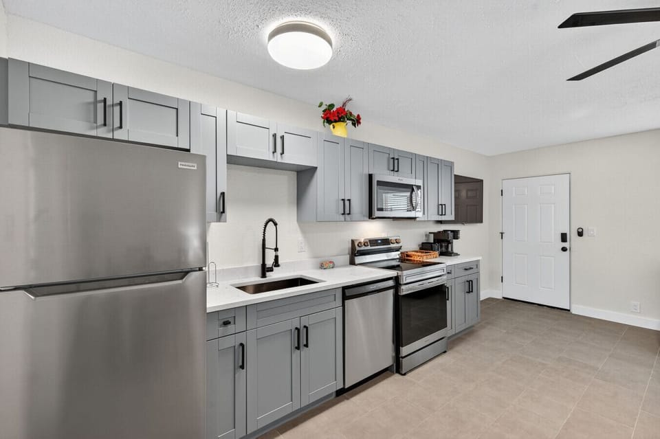 Modern kitchen w/ stainless steel appliances and plenty of counter space for easy cooking.