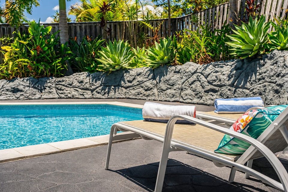 Your own outdoor retreat featuring a crystal-clear pool and cozy lounging area.