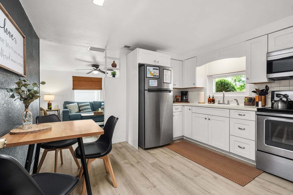 Fully furnished kitchen with amenities like a refrigerator, stove, oven, water kettle, and coffee maker.