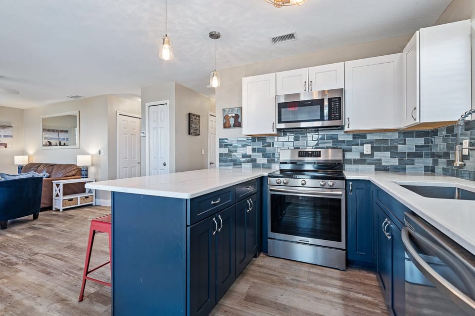 Outfitted with modern appliances, including a full-size refrigerator, oven, microwave, and dishwasher, it's ready for everything from quick breakfasts to full family dinners.