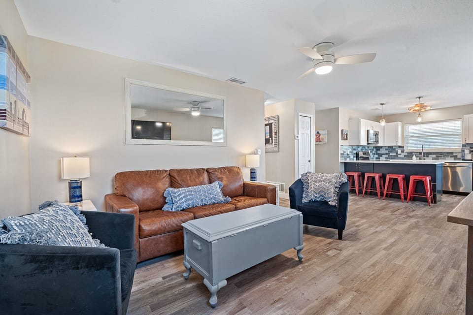 With an open layout that flows seamlessly into the kitchen, it's perfect for gathering with family or relaxing after a day at the beach.