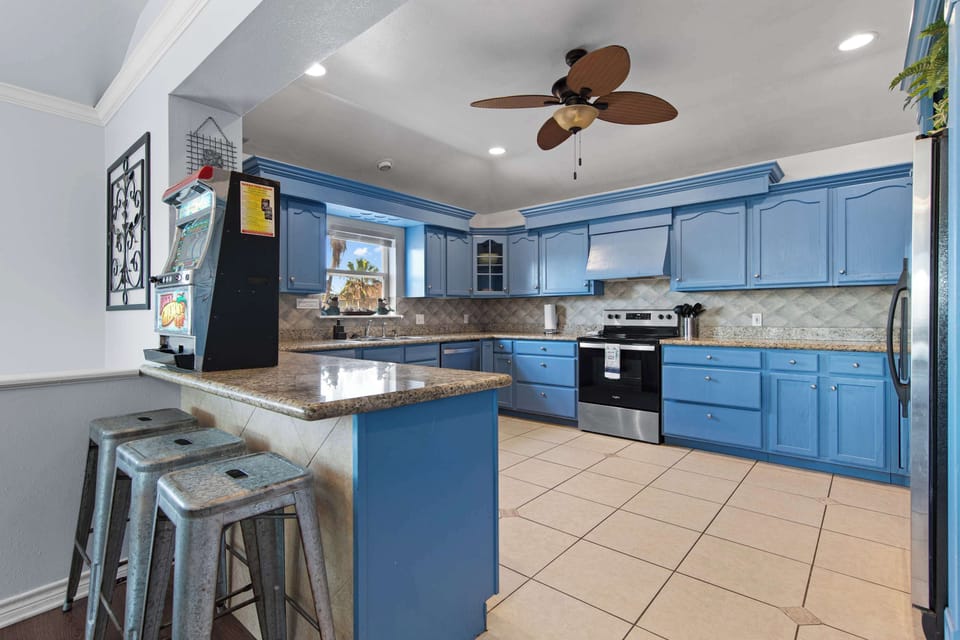 Granite counters, bar seating, and a classic arcade game close by