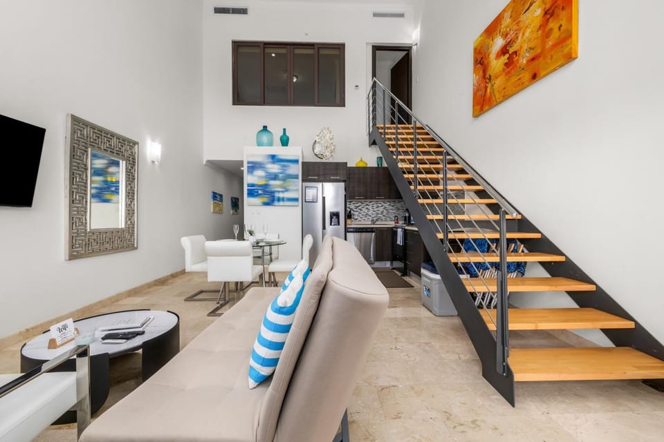 Step into this inviting living room with a stylish staircase leading you to the cozy bedroom upstairs. Perfectly designed for comfort and privacy, this space offers a unique blend of openness and charm.