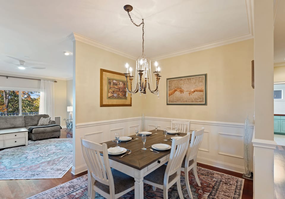 Dining room with a table set for four and elegant decor.
