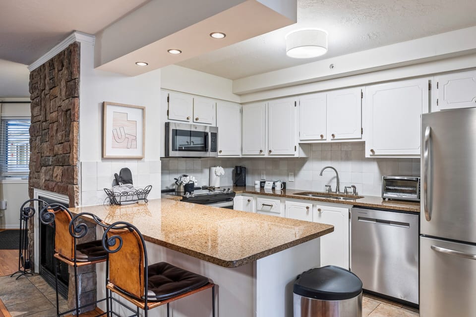 bright, updated kitchen with stainless steel appliances, granite countertops, and bar seating. Fully equipped for cooking and entertaining, this space makes dining in a pleasure.