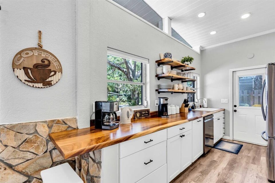 Kitchen equipped with coffee bar & dishwasher.