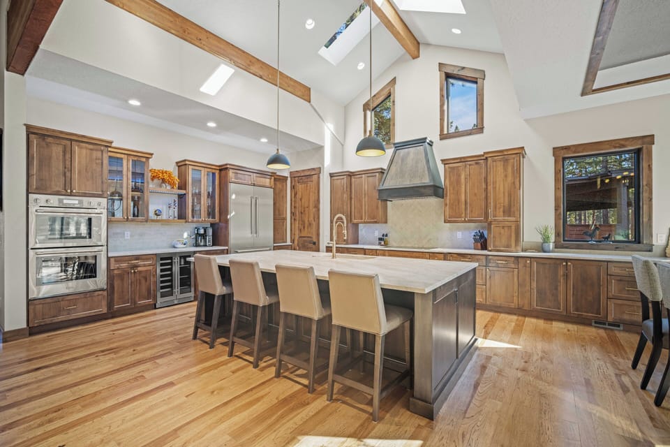 Your gourmet kitchen features soaring ceilings, exposed beams, and premium appliances perfect for creating memorable meals together.