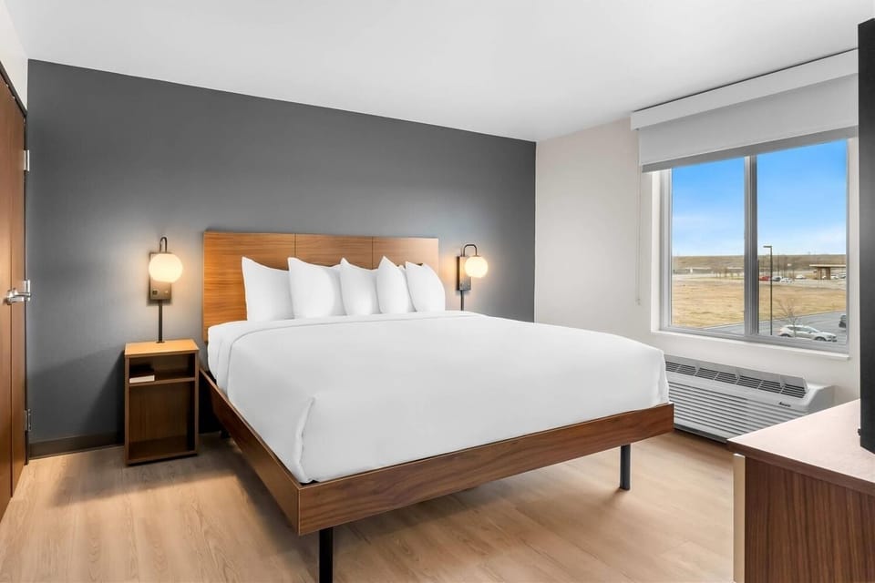 Unwind in a crisp king bed beside sunlit windows.