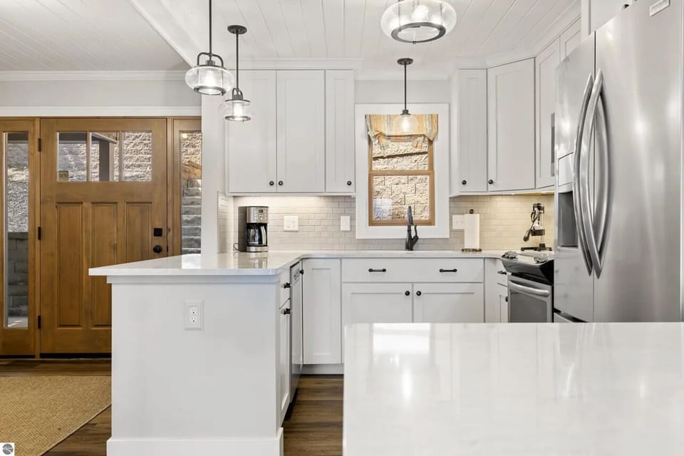 KITCHEN (MAIN FLOOR):  The home has a beautiful modern kitchen with all appliances (including a dishwasher) and a good supply of cooking and dining utensils