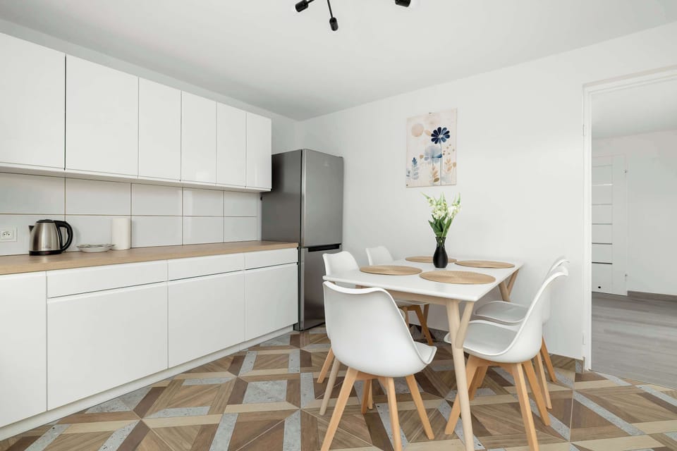 The kitchen's sleek design includes all necessary cookware and utensils.