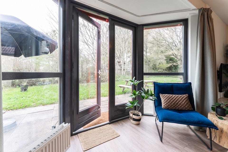 Bright living room at Groenenheuvels House with direct garden access — enjoy peaceful views in Holiday Park Groene Heuvels Ewijk.