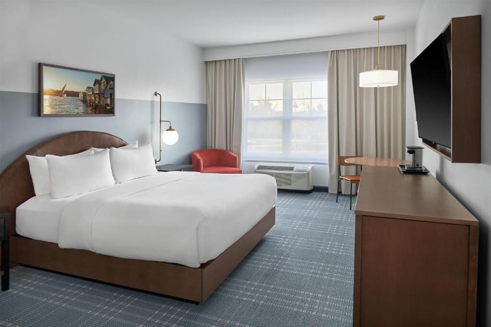 Unwind in a crisp king bed with modern comforts.