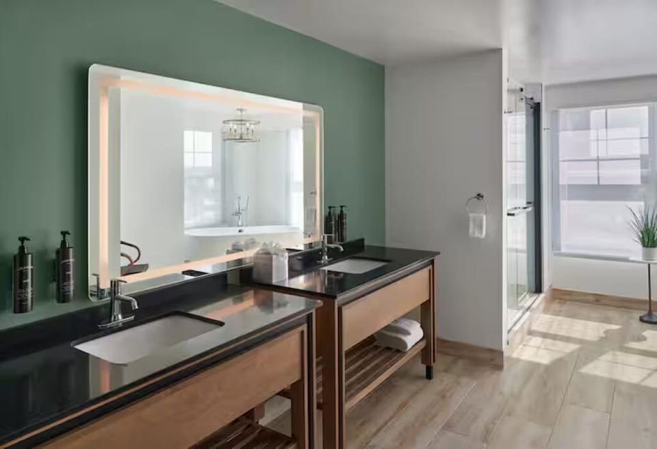 Refresh at the double vanity under flattering, spa-like lighting.
