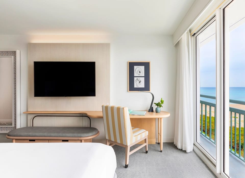 Catch up on emails beside sunlit windows and coastal views.