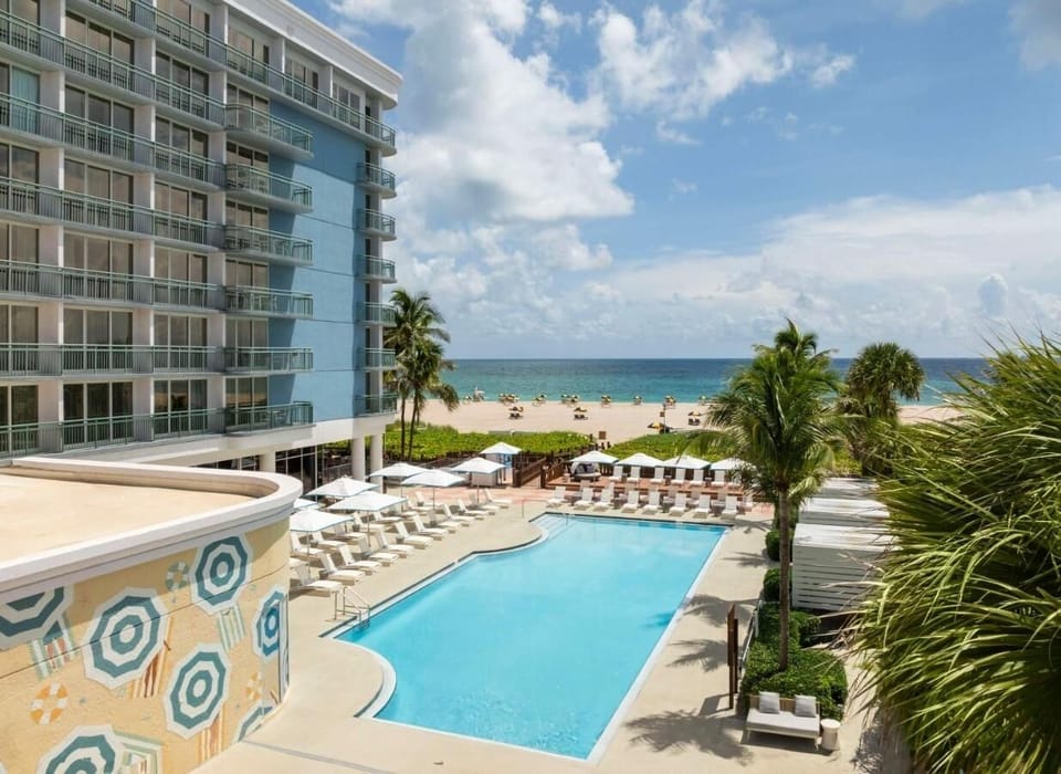 Soak up sunshine beside the pool steps from the beach.