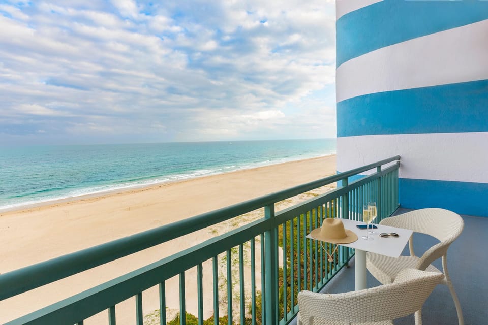 Toast sunsets on your private balcony overlooking the sandy shore.