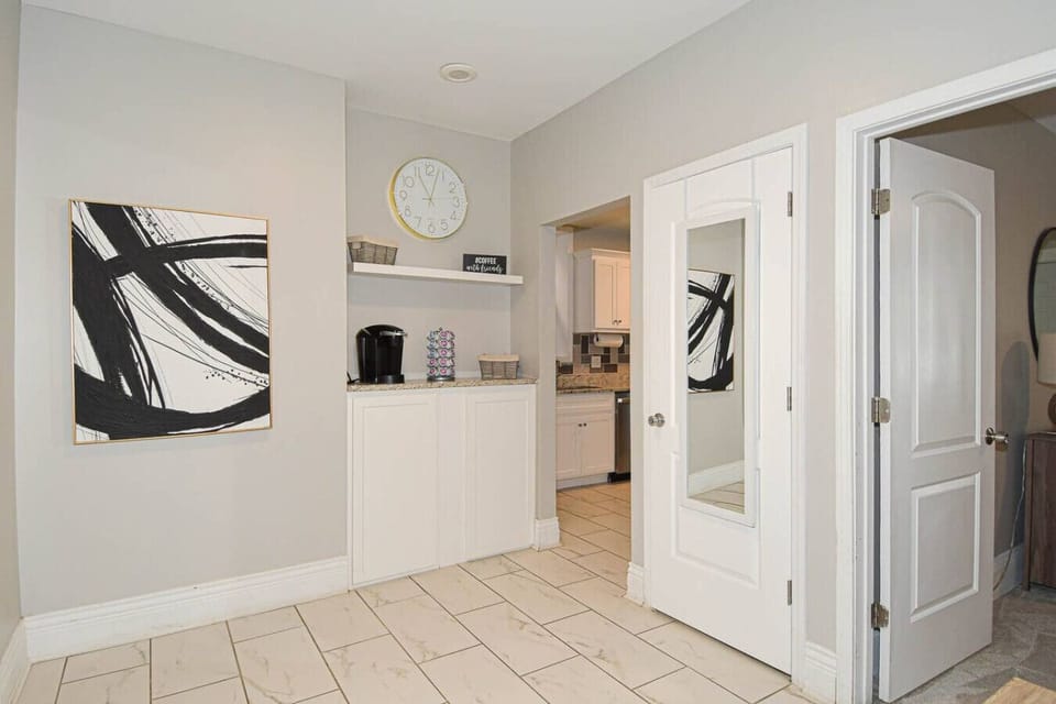 Dedicated coffee station with Keurig, supplies, and extra storage for guest convenience