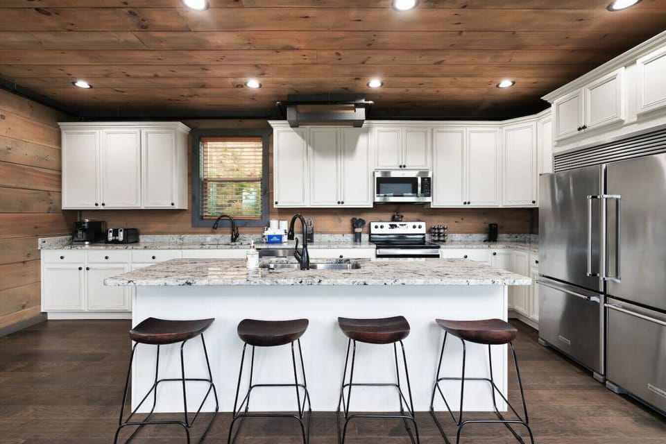 A chef’s delight in the heart of the Smokies—this open-concept kitchen blends warmth and function with high-end appliances, generous prep space, and bar seating for sharing stories over snacks.