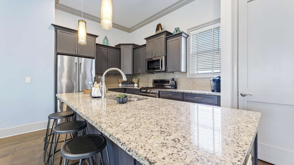 Bright open kitchen with modern appliances and plenty of counter space overlooking the living and dining rooms.