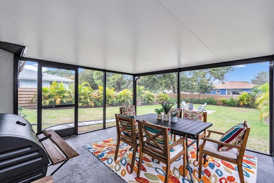 A backyard patio oasis with an outdoor table for al fresco dining and a charcoal grill for sizzling BBQs. Perfect for gatherings and evenings.